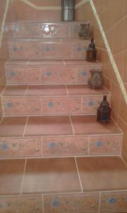 a set of stairs with flowers painted on them at Villa Haidra in Dar Merah Deriba