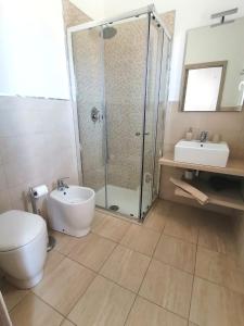 a bathroom with a shower and a toilet and a sink at Piccolo Ulivo B&B Salento in Vernole +55 photos