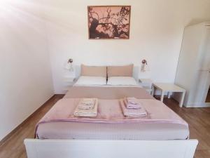 a bed with two towels on it in a room at Piccolo Ulivo B&B Salento in Vernole
