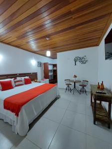 a bedroom with a large bed with a wooden ceiling at Pousada Canoa Caiçara Ilhabela in Ilhabela +102 photos