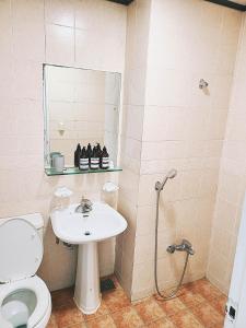 a bathroom with a toilet and a sink and a shower at Villae Resort in Jeju