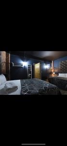 a bedroom with two beds and lights on the wall at Swan Street Townhouse Hot Tub & Roof Terrace in Manchester +8 photos