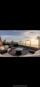 a view of a patio with a table on a deck at Swan Street Townhouse Hot Tub & Roof Terrace in Manchester