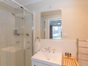 a bathroom with a shower and a sink and a mirror at St Helenas 5 Twynam Street in Jindabyne +9 photos