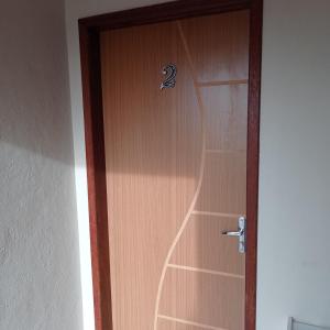 a wooden door with the number two on it at Jockey Apto 2 in Campos dos Goytacazes