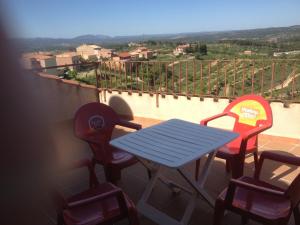 a table and chairs on a balcony with a view at Apartaments la Fabrica in Horta de San Joan