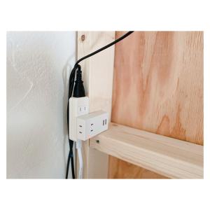a black and white electrical outlet on a wall at ゲストハウスよるよなか in Nagoya