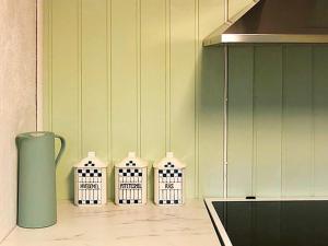 a kitchen counter with four white baskets on it at Holiday home bremnes II in Bremnes