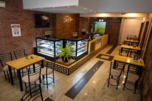 a restaurant with two tables and chairs and a counter at Kohinoor Hotels in Erode