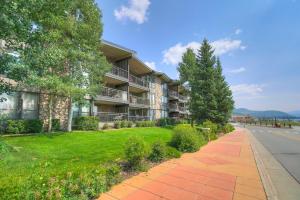an apartment building with a lawn and a sidewalk at Mountain luxury on Lake Dillon, close to all the best ski resorts in Colorado! in Dillon