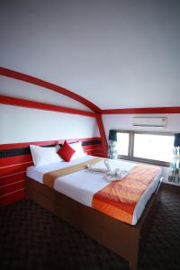 a bedroom with a large bed in a room with a window at Friends Cruise, Nightstay Houseboat in Alleppey