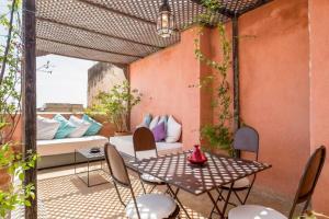 a patio with a table and chairs and a couch at COZY BUT TRENDY RETREAT IN MEDINA in Fez