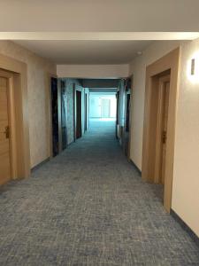 an empty hallway in a building with a hallway at Alcor Beach Hotel in Mamaia