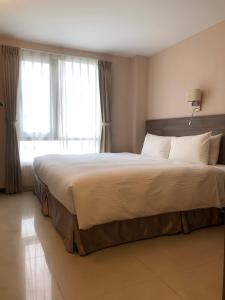 מיטה או מיטות בחדר ב-Hotel Leisure Beitou