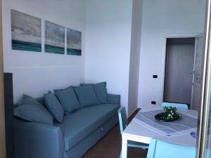 a living room with a couch and a table at La Casa Sulla Scogliera in Cefalù