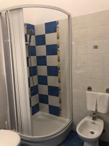 a bathroom with a shower and a toilet and a sink at La Casa Sulla Scogliera in Cefalù