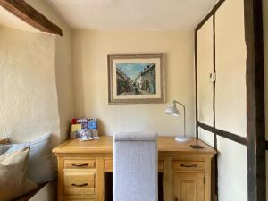 a room with a desk with a lamp on it at Number 22, Castle Street in Hay-on-Wye