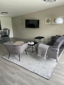 a living room with a couch and a table at Strandkieker 4 nur 500m zum Strand in Ueckermünde