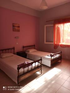 ダシアにあるVilla Siaの赤い壁のベッドルームにベッド2台が備わります。