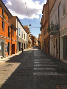 a person walking down a street in an alley at Casa Maka' in Olbia