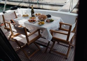 a table with plates of food on a boat at BB Boat Lady A in Genova