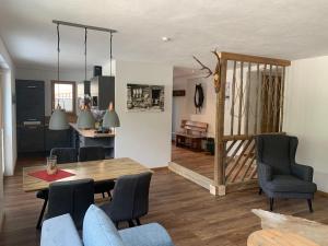 a dining room and living room with a table and chairs at Appartements Wolfgang Auderer in Jerzens