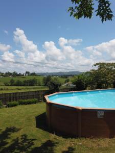 a large swimming pool in the yard of a house at Le Petit Couvent in Musculdy