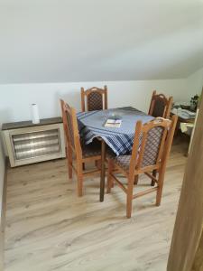 a dining room with a table and chairs and a radiator at Smeštaj Urošević in Golubac