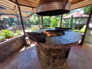 a stone fire pit in a patio at Villa Onix in Sinaia