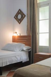 Postel nebo postele na pokoji v ubytování Hostal Colón