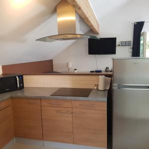 a kitchen with a refrigerator and a stove at Studio Haras in Wavre