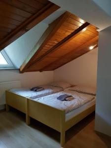 a bedroom with two beds in a attic at Studio apartman Ivana in Jajce +3 photos