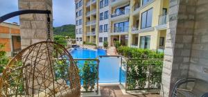 a view from the balcony of a building with a swimming pool at MonteDreams Royal in Budva