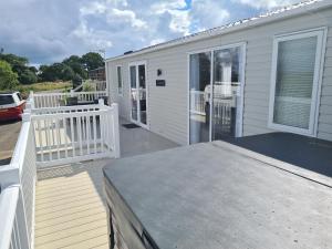 a house with a large deck with a porch at Jacaranda in Felton