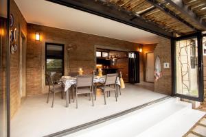 an outdoor patio with a table and chairs at Blaauw Cottage in Riebeek-Kasteel