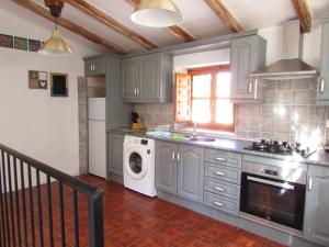 a kitchen with a washing machine and a washer at Cortijo tranquilo, Albanchez, Almeria Province in Albánchez