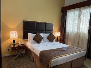 Кровать или кровати в номере Downtown Plaza Hotel Apartment Pet Friendly