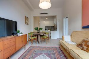 a living room with a couch and a table at Mamo Florence - Cavour Apartments in Florence