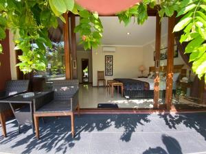a bedroom with a bed and a table and chairs at Jepara Marina Beach Bungalows in Jepara