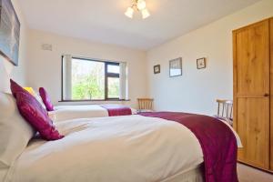 a bedroom with two beds and a window at Kents Bank Holiday - Pet Friendly with Bay Views in Grange Over Sands