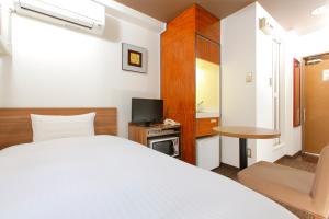 Postel nebo postele na pokoji v ubytování FLEXSTAY INN Kawasaki Ogawacho