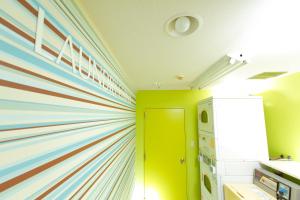 a room with a colorful wall with a refrigerator at FLEXSTAY INN Kawasaki Ogawacho in Kawasaki