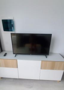 a flat screen tv sitting on top of a white cabinet at Atlantic View 1B 2 Bedrooms Ground Floor, Complex featured on A Place in The Sun in Puerto del Carmen