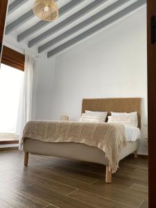 a bedroom with a large bed with a striped ceiling at Casa Carmen by VG in Maro