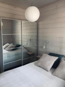 1 dormitorio con 1 cama y pared de cristal en Ylläs Fell Inn, en Äkäslompolo