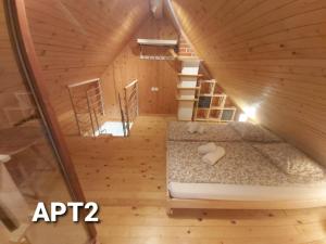 an attic bedroom with a bed in a wooden house at Alpine Village Home in Bohinj
