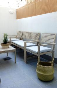 a group of chairs and a table and a bench at UIM Mediterraneo PB Felipe 1 Wifi in Puerto de Sagunto