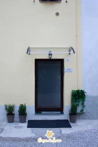 a black door on the side of a building with plants at Casa di Irene in Reggio Emilia