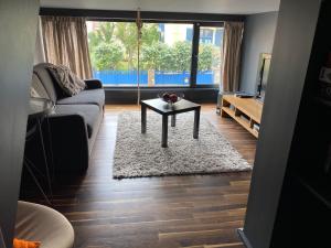 a living room with a couch and a coffee table at Gîte 1908 avec GARAGE in Wimereux