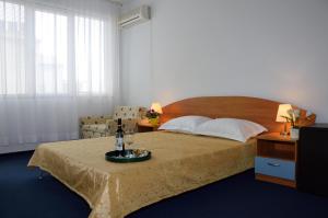 a bedroom with a bed with a tray of food on a table at Villa Diana in Sozopol +48 photos